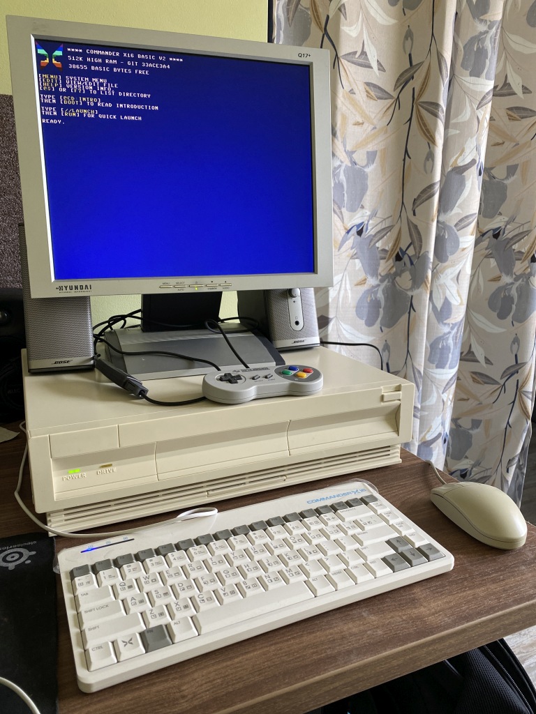 Completed setup with old LCD monitor, speakers, Classic SNES gamepad, keyboard and mouse